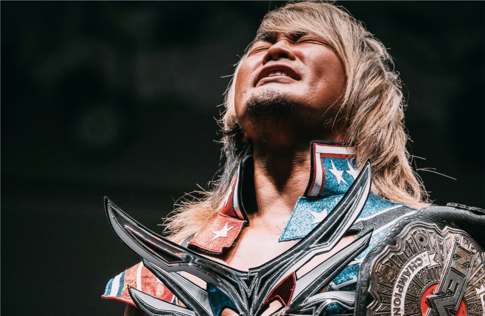 Photograph of Hiroshi Tanahashi holding the NEVER Openweight Championship in New Japan Pro Wrestling