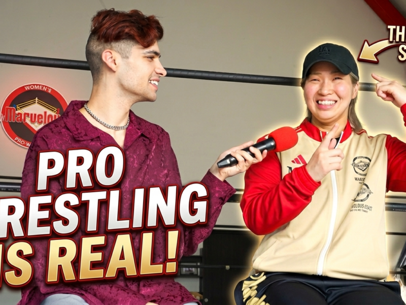 Interviewer holds a red mic as a wrestler talks in a ring, with the bold text ‘PRO WRESTLING IS REAL!’.