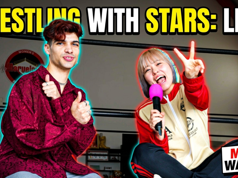 Two hosts in a boxing ring posing for a live show thumbnail: man thumbs up, woman with pink mic flashing a peace sign; bold 'WRESTLING WITH STARS: LIVE!' and 'MUST WATCH!' text above them.