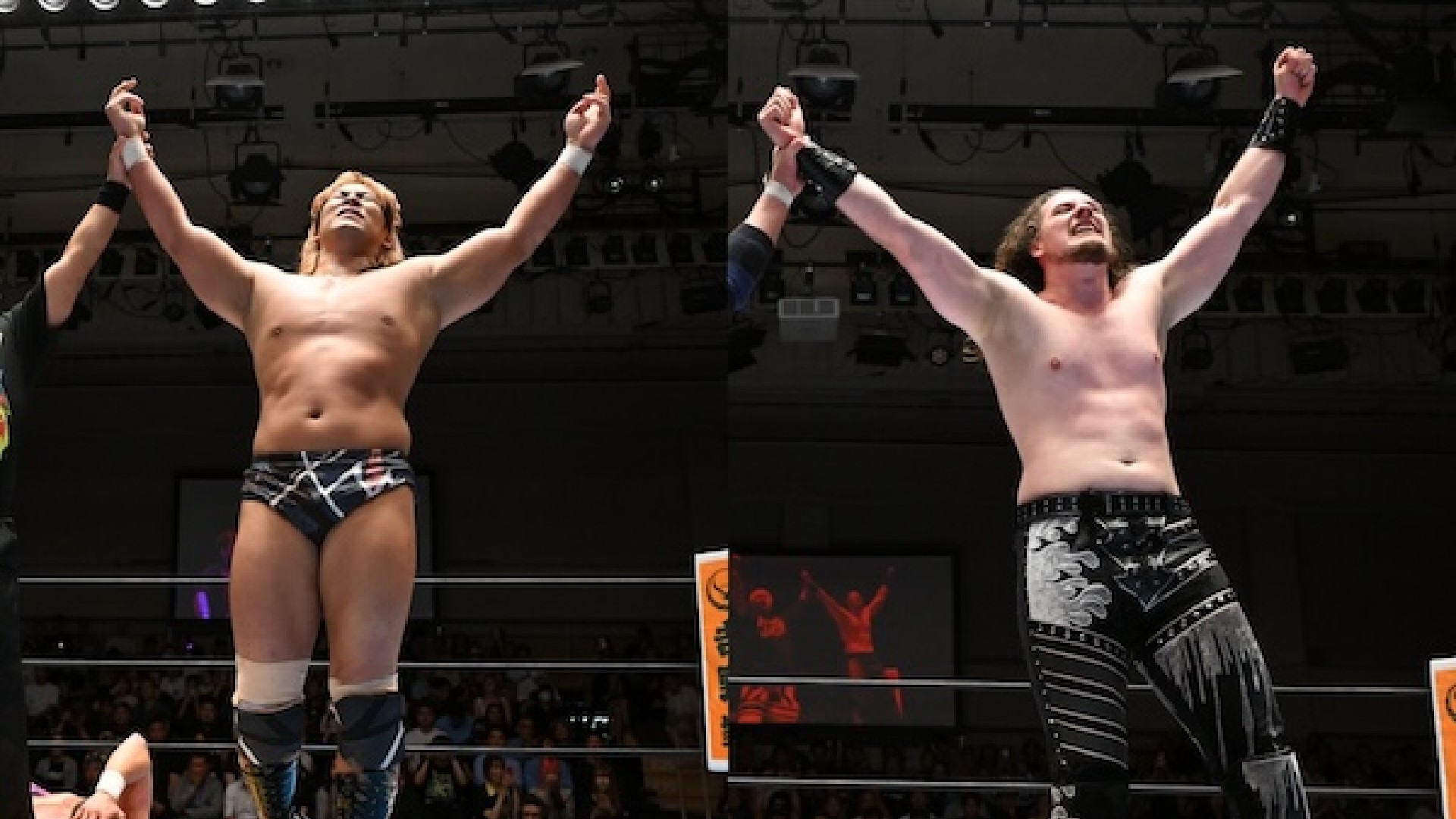 Two shirtless wrestlers in a ring raise their arms in victory as the crowd cheers in the background.
